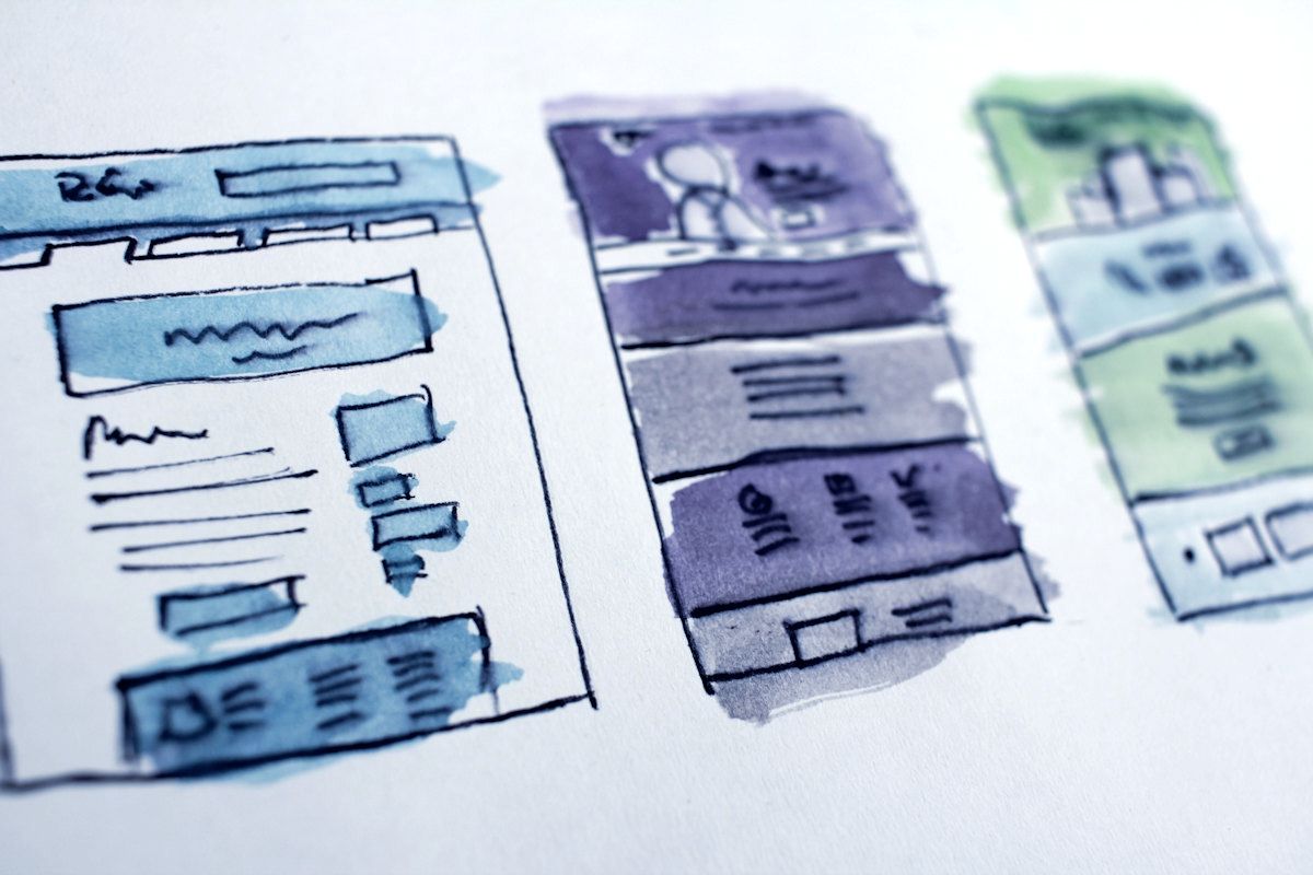 Hand-drawn wireframes of web page layouts.